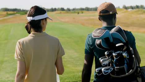 Caucasian-woman-and-african-american-man-meeting-on-the-golf-course.