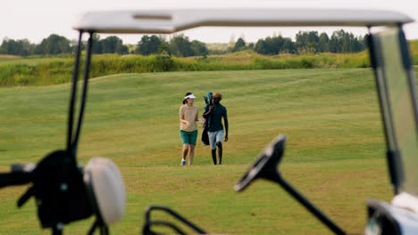 Caucasian-woman-and-african-american-man-on-the-golf-course.