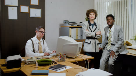 Caucasian-businessman-using-a-retro-computer-in-vintage-office.