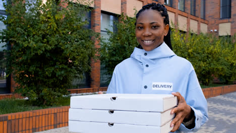 Young-woman-holding-pizza-boxes