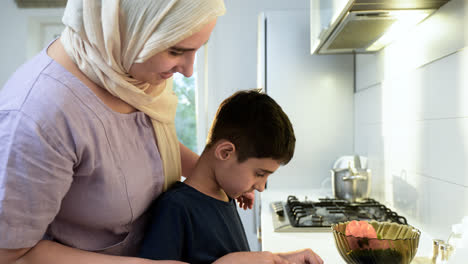 Cllose-up-view-of-mother-with-hiyab-and-her-son-in-the-kitchen.