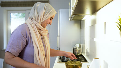 Side-view-of-woman-with-hiyab-in-the-kitchen.