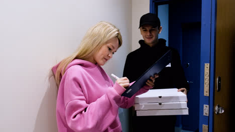 Delivery-guy-with-pizzas-and-a-clipboard