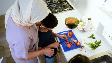 Top-view-of-mother-with-hiyab-and-her-son-in-the-kitchen.