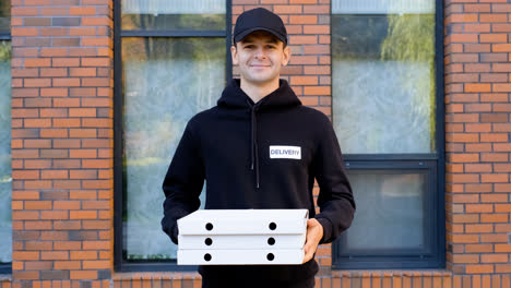 Young-man-holding-pizza-boxes