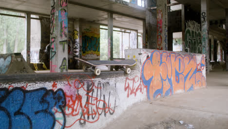 Skateboard-on-the-wall-in-a-ruined-building.