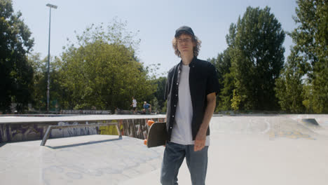 Caucasian-boy-walking-in-skatepark.