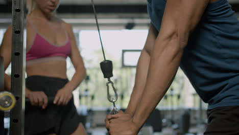 Close-up-view-of-african-american-man-and-caucasian-female-monitor-in-the-gym