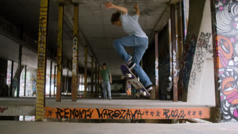Caucasian-boys-skateboarding-in-a-ruined-building.