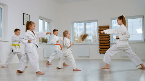 Kids-in-white-kimono-in-martial-arts-class