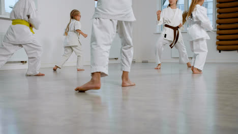Unrecognizable-kids-in-white-kimono-in-martial-arts-class