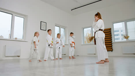 Caucasian-martial-arts-teacher-teaching-kids