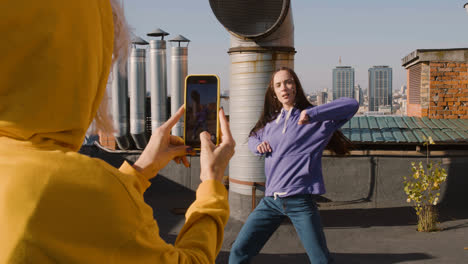 Back-view-of-a-woman-recording-her-friend