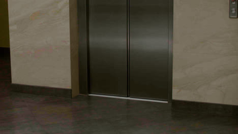 Woman-exiting-the-elevator-in-the-hotel-hall