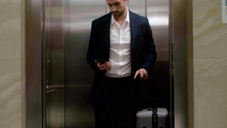 Man-exiting-the-elevator-in-the-hotel-hall