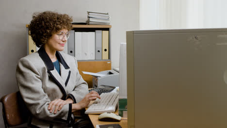 Caucasian-businesswoman-working-sitting-at-desk.