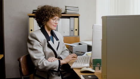 Caucasian-businesswoman-working-sitting-at-desk.
