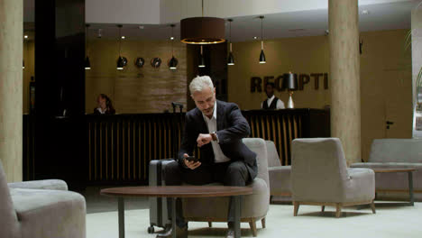 Man-sitting-on-the-sofa-in-the-hotel-reception-area