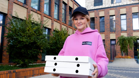 Young-woman-holding-pizza-boxes