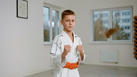 Boy-in-white-kimono-in-martial-arts-class