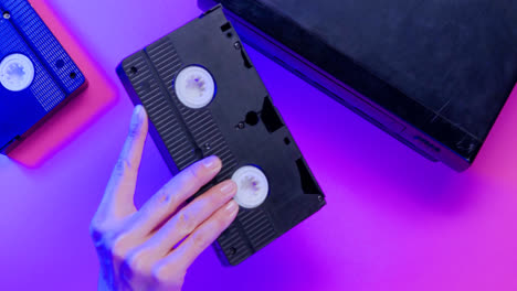 Draufsicht-Auf-Video-VHS-Gerät-Und-Kassette-Auf-Lila-Hintergrund