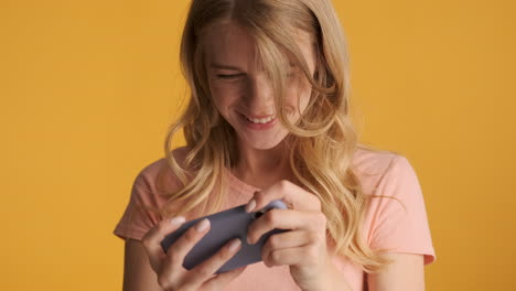 Caucasian-woman-playing-video-games-on-smartphone.