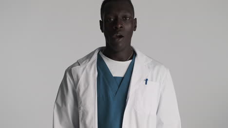 Tired-African-american-doctor-on-grey-background.