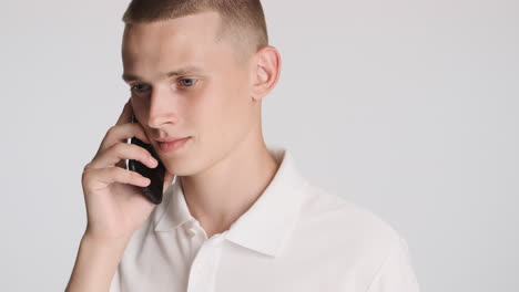 Young-guy-using-smartphone-for-talking