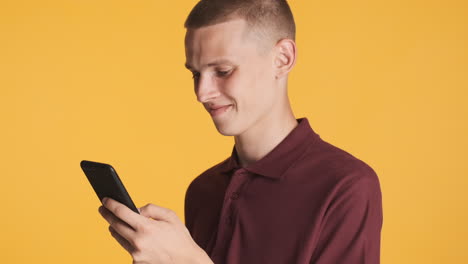 Young-man-looking-at-his-smartphone