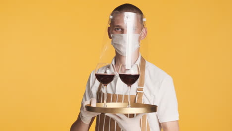 Young-man-with-face-mask,-serving-red-wine
