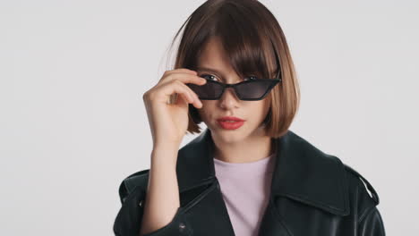 Brunette-woman-putting-sunglasses-on