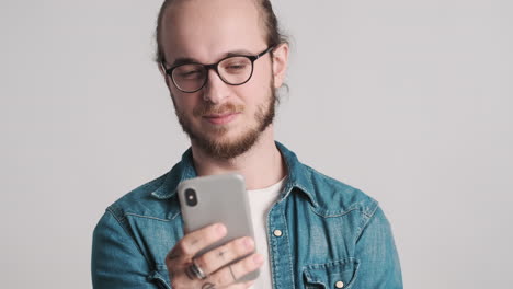 Caucasian-young-man-using-smartphone-on-camera.