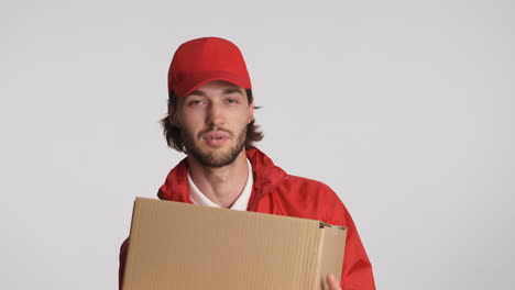 Caucasian-delivery-man-in-front-of-camera-on-white-background.