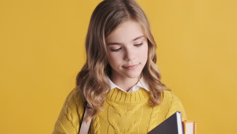 Happy-teenage-Caucasian-girl-student-holding-notebooks.