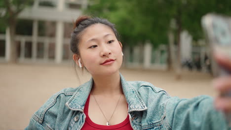 Asian-woman-recording-video-in-the-park.