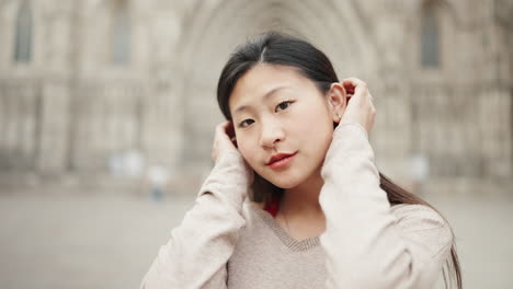 Asian-girl-looking-to-the-camera-outdoors.