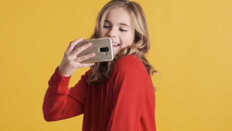 Teenage-Caucasian-girl-taking-pictures-on-her-smartphone.