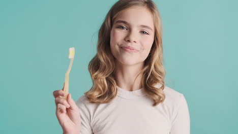 Teenage-Caucasian-girl-in-pijamas-holding-toothbrush.