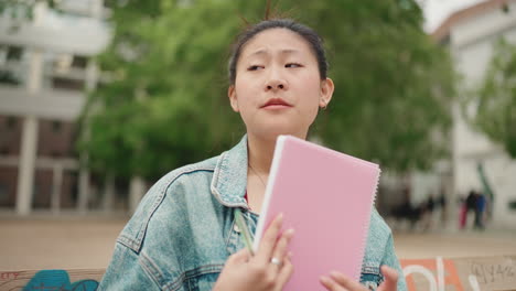 Asian-girl-studying-outdoors.