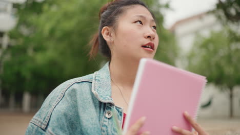 Asian-girl-studying-outdoors.