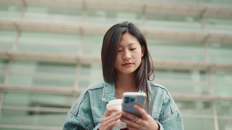 Asian-woman-drinking-coffee-outdoors.