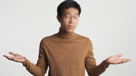 Asian-man-showing-i-don't-know-gesture.