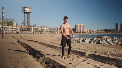 Conceptual-shot-of-young-muscular-man-doing-somersault-or-side-flip-during-workout-by-the-sea