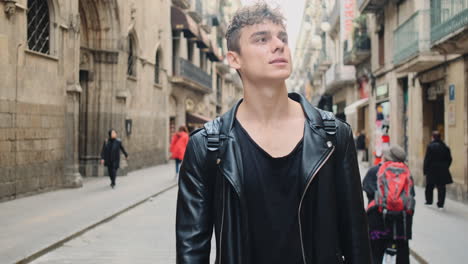 Young-handsome-man-confidently-walking-through-busy-city-street