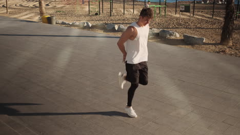 Young-sporty-man-doing-exercises-during-functional-training.-Fit-guy-on-workout-outdoor