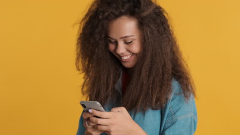 Caucasian-curly-haired-woman-texting-on-smartphone.