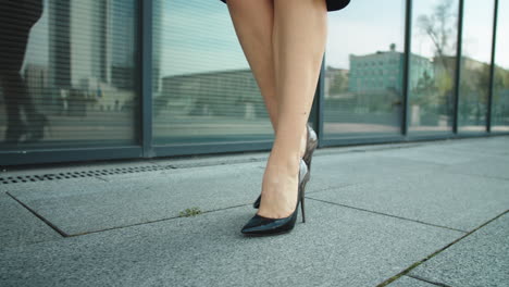 Woman-legs-walking-in-high-heel-shoes-outside