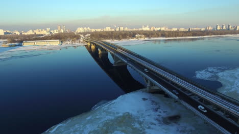 Car-traffic-on-bridge-highway-at-winter-city-landscape
