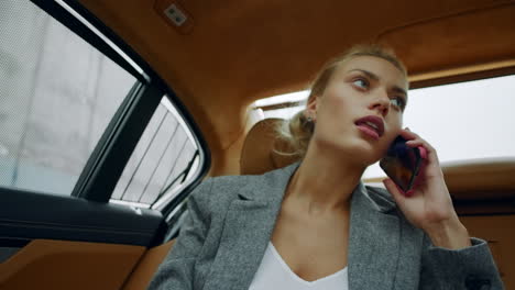 Woman-riding-on-the-backseat-at-luxury-car