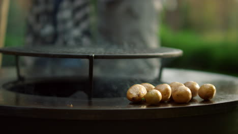 Man-preparing-potato-in-backyard